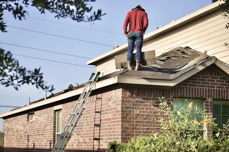 Professional roofer working on a residential roof in New Bern